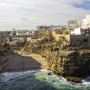 Charming coastal town with cliffside buildings overlooking the sea and vibrant Mediterranean architecture.