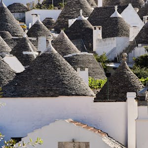 Scenic view of traditional Trulli houses with conical roofs in Alberobello, Apulia, Italy.